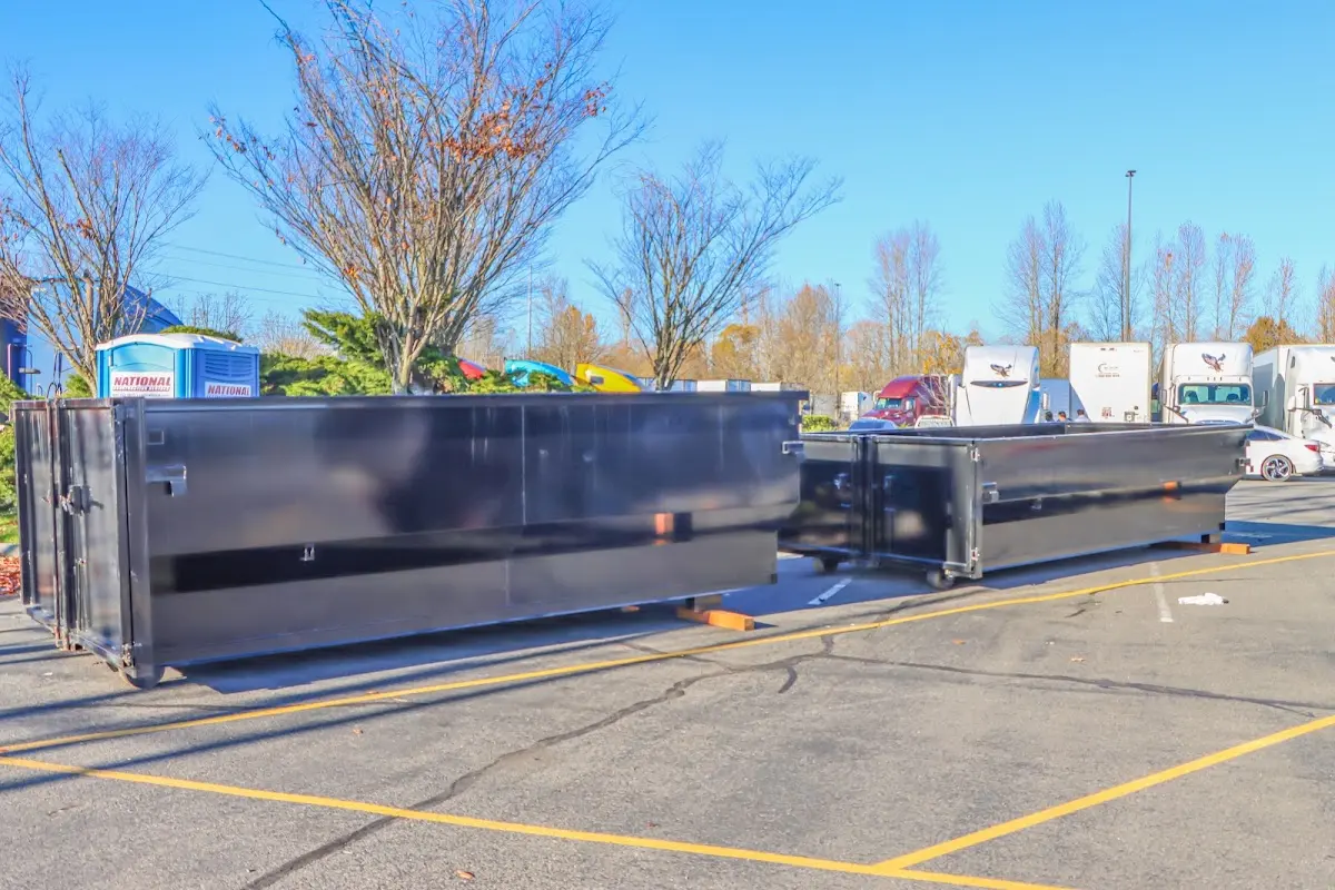 Professional dumpster rental service with roll-off container on residential driveway in Lyndon